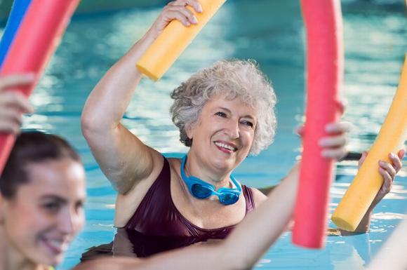 Older lady in pool doing Aqua Aerobics