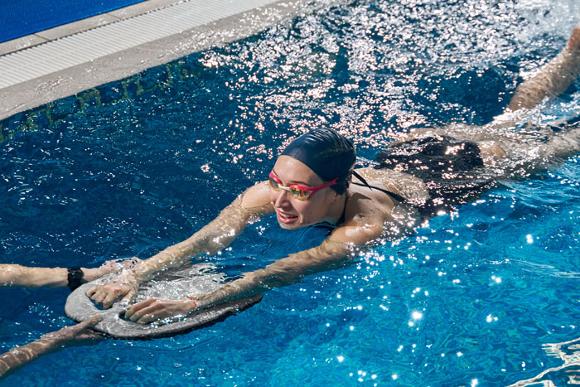 lady in pool learning to swim